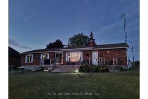 Enjoy this solid lakeside bungalow, featuring 3 bedrooms, 2 upgraded bathrooms, a kitchen with granite counter tops, a breakfast bar, hardwood floors in living room and all bedrooms, and a ...