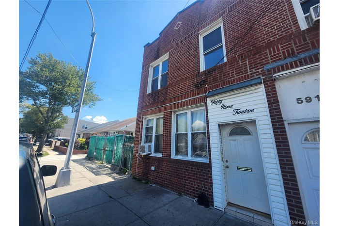 Doorway to property featuring brick siding