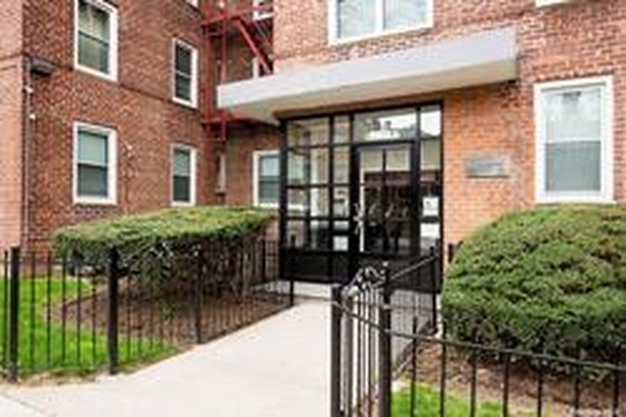 Entrance to property with brick siding and fence