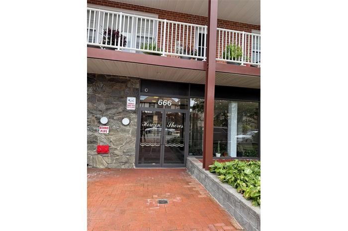 Entrance to property featuring stone siding and french doors