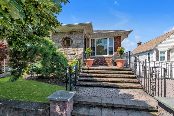 Doorway to property with stone siding and brick siding