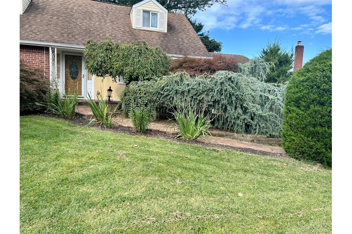 View of grassy yard featuring a patio area