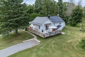Nestled on a spacious half acre lot, this thoughtfully reimagined 2 bedroom bungalow captures the essence of County living.