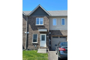 Experience the best of both worlds in this unique bungalow style townhouse, bathed in an abundance of natural light !
