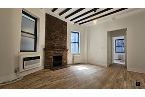 The charming and cozy 1BR 1Bath pre war Co op, 11ft high beamed ceilings with a wood burning fireplace exposed brick.