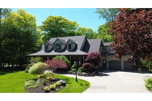 Take a look at this stunning home, nestled on just under an acre of lush, mature trees and beautifully enhanced with professional landscaping.