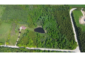 Welcome to this impressive, custom built home, privately nestled on 22 acres and set well back from the road.