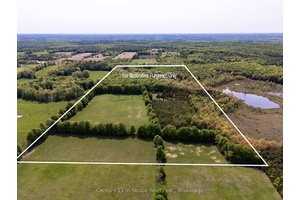 Tranquil 49 acre retreat with a breathtaking 2008 Shouldice Stone bungalow nestled behind a serene pond.