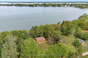 This spectacular 1. 22 acre property with cottage has 160 feet of beautiful waterfront, overlooking West Lake and the Sandbanks Provincial Park.
