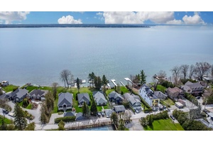 Boasting a rare sandy shoreline, a private dock, this waterfront home invites you to indulge in the tranquil beauty of lakeside living.