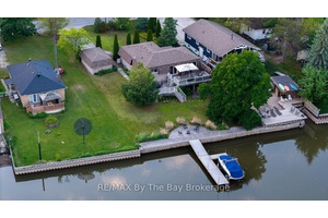 Waterfront retreat that offers year round living on the prime boating part of the Nottawasaga River in Wasaga Beach a convenient short walk to the pristine sandy shores of beautiful ...