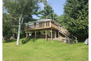 Attention water lovers and fishermen This lovely 4 bedroom, 2 bathroom cottage is located within a short walk to a large public beach and public boat launch on Chandos Lake.
