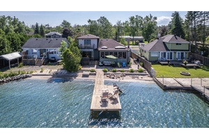 This charming 1 storey home offers the perfect blend of comfort, character, and stunning water views with direct access to your own hard sand beach with crystal clear water.
