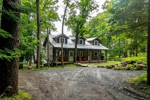 Nestled halfway down a private, year round laneway, this beautiful log cottage or home on the shores of Lake Vernon offers an idyllic retreat that blends rustic charm with modern ...
