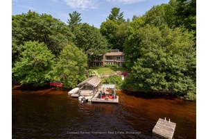FRESHLY RENOVATED Impressive year round home or cottage resting on one of the most desirable park like properties on Lake Vernon, with 1.