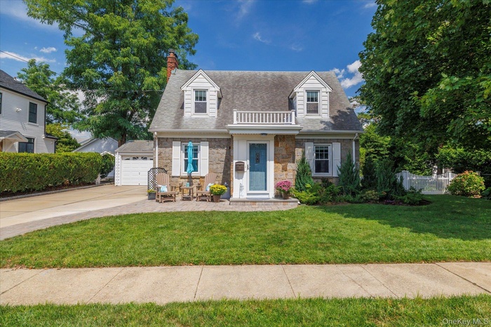 Cape cod home featuring Fieldstone Brick Attached Garage