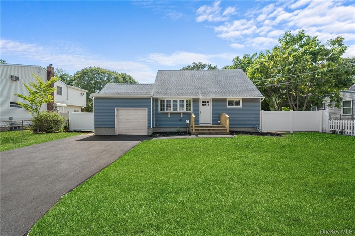 View of front of house featuring asphalt driveway, a shingled roof, and an attached garage