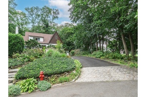English Tudor surrounded by charming gardens in Manhasset Bay Estates.