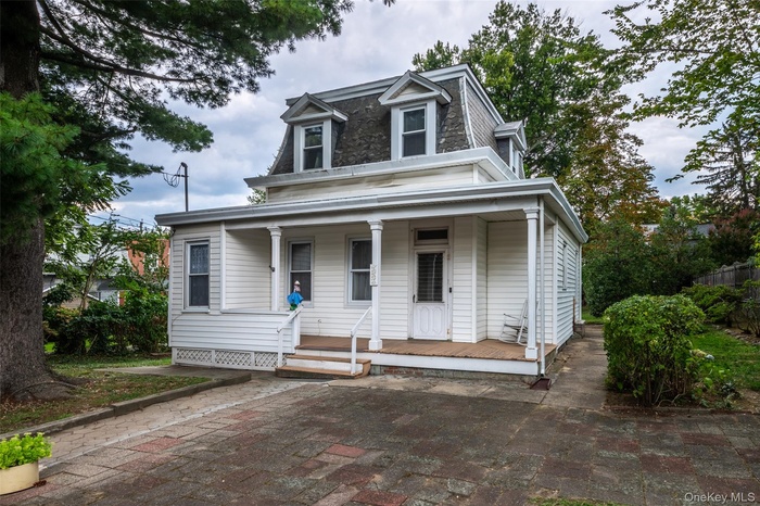 Victorian home featuring a covered porch