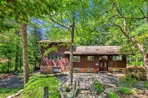 TUXEDO ! Mid Century Scenic Country Retreat Nestled among the trees in the sought after Laurel Ridge community, this custom home blends rustic charm with contemporary design.