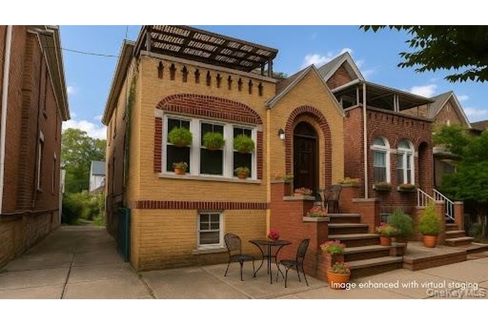 Rear view of property featuring brick siding