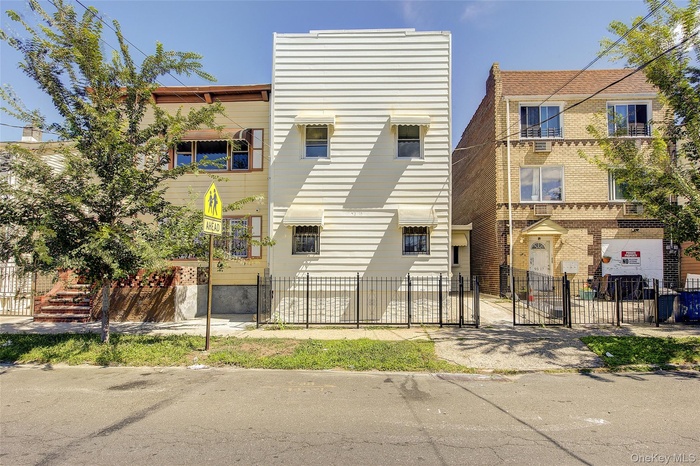 View of building exterior featuring a fenced front yard