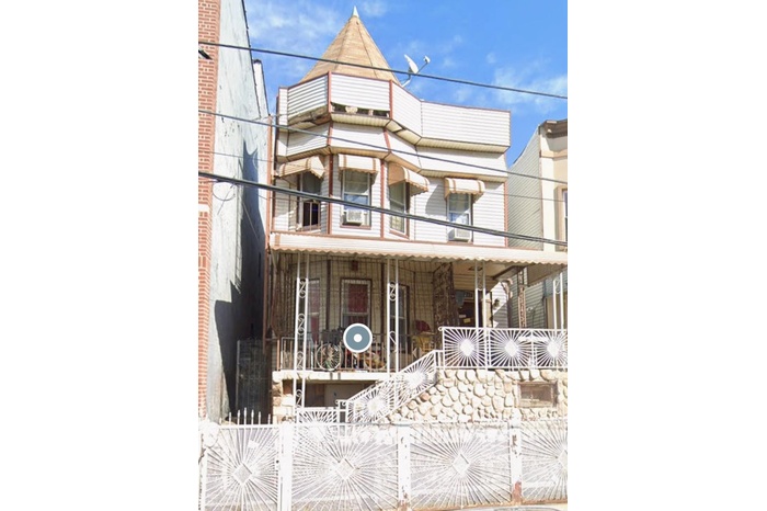 Victorian house featuring a porch, fence, and a balcony