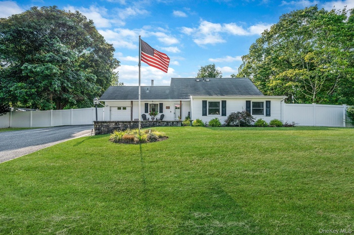 View of front facade with asphalt driveway and an attached garage