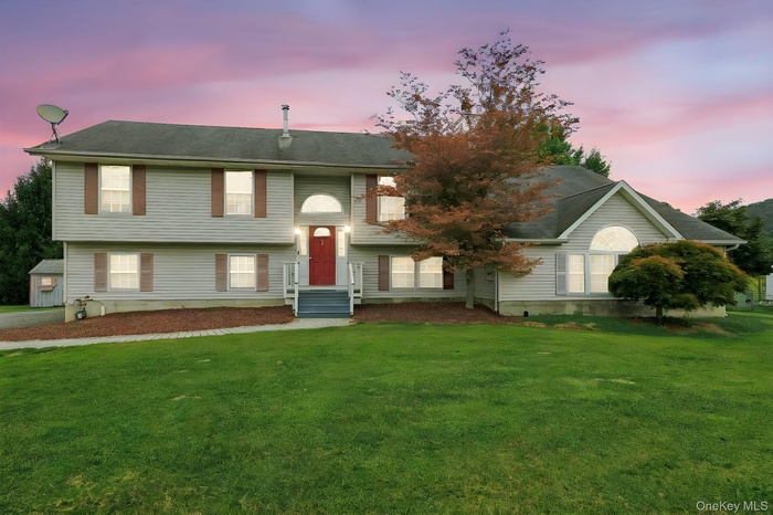 Split foyer home with a lawn