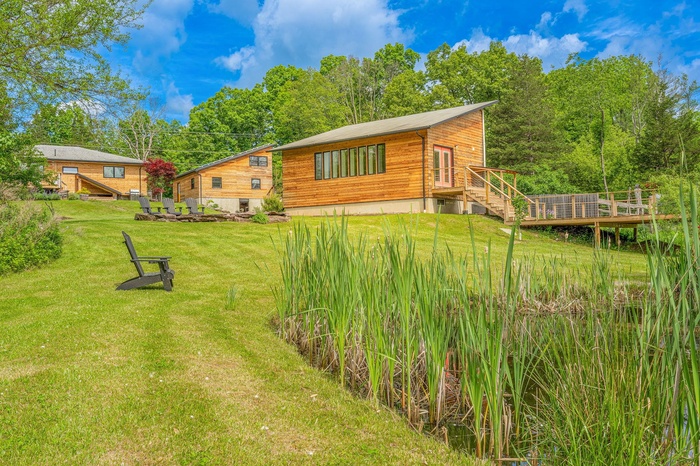 Rear view of property with a lawn and a deck
