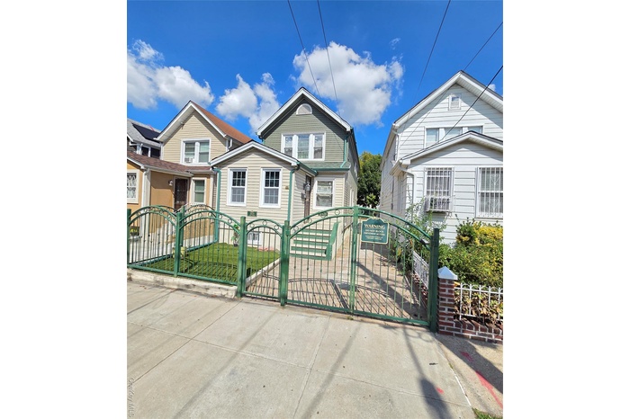 View of front of property with a gate and a fenced front yard