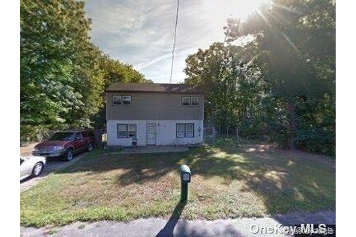 View of front of property with a front lawn