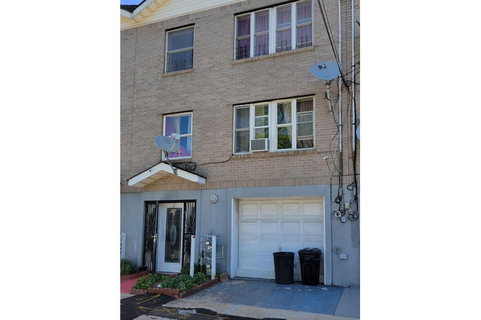Multi unit property with brick siding and a garage