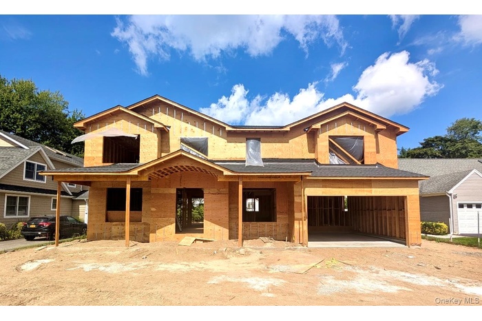 Property in mid-construction with a porch and a garage
