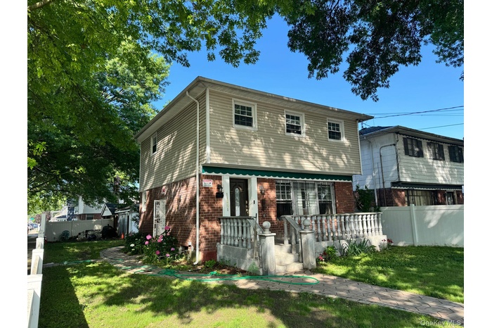 View of front of property with brick siding and a porch