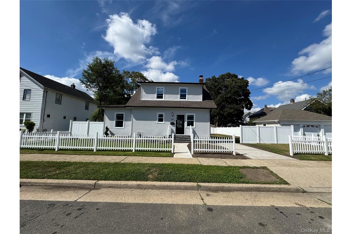 Bungalow-style house with roof with shingles, a chimney, and a fenced front yard