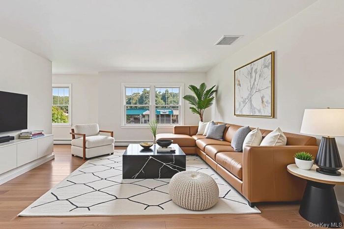 Spacious Living room with plenty of natural light, light wood-style floors