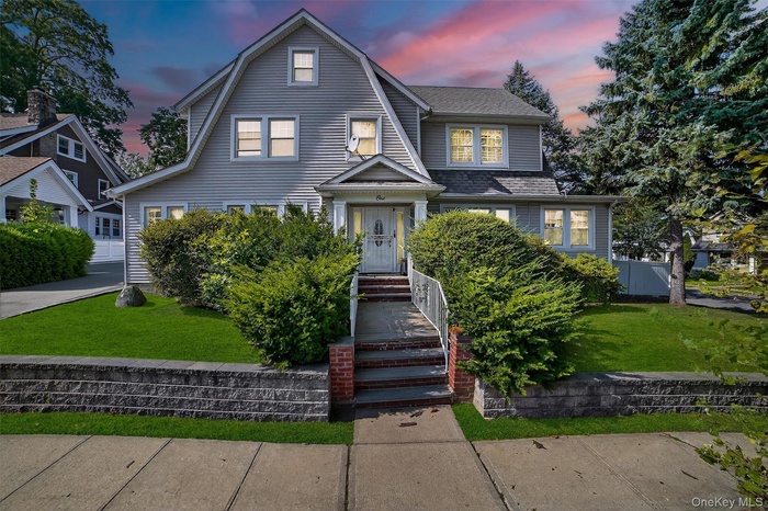 Dutch colonial with a yard and a gambrel roof