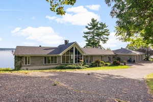 Panoramic views of the Ottawa River from this stunning custom built bungalow !