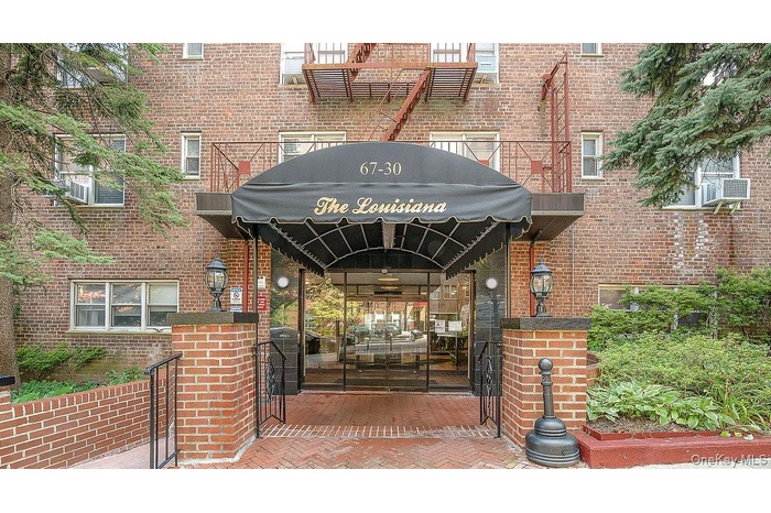 View of exterior entry featuring brick siding