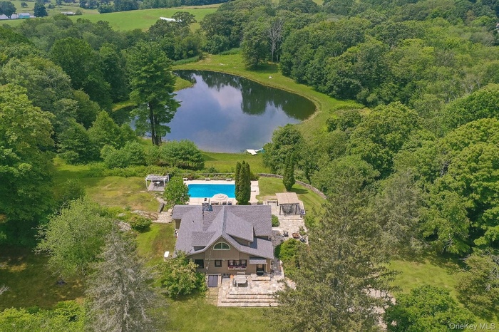 Aerial overview of property's location with a large body of water
