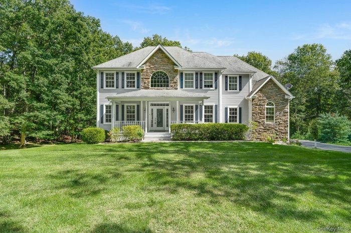 Colonial home with stone siding and front porch
