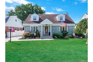 Welcome to this beautiful wide line cape, ideally located on a quiet street in the Herricks School District, just steps from Park Circle.