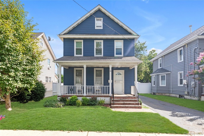 Traditional style home featuring covered porch