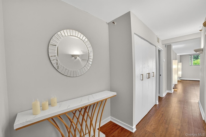 Hallway featuring wood finished floors and baseboards