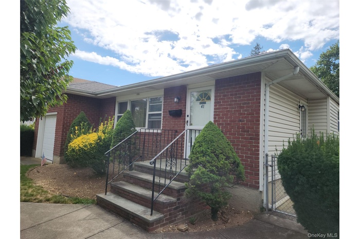 Single story home with an attached garage and brick siding