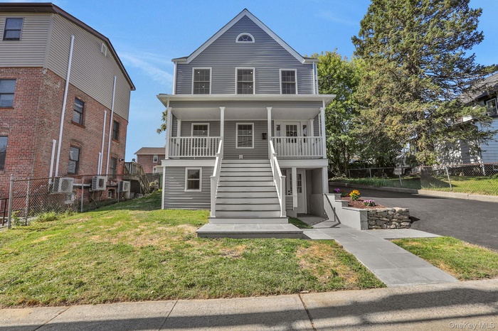 View of front of home with stairs and covered porch