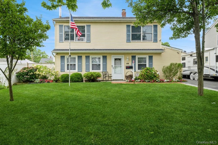 View of front of property featuring a front yard and a chimney