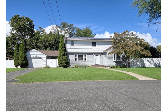 Colonial home featuring a garage and driveway