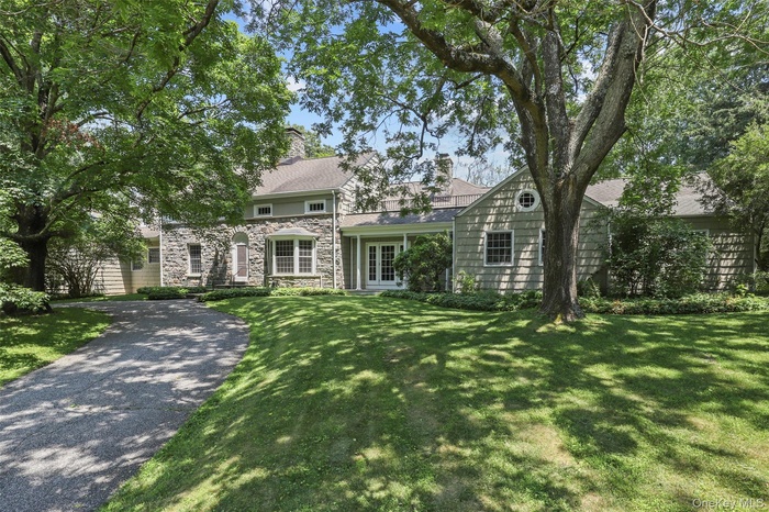 View of front of property featuring stone & wood shake